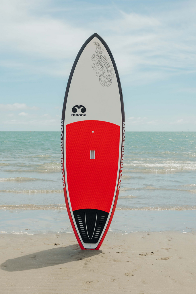 Moana Kahawai red surf stand up paddleboard on the beach