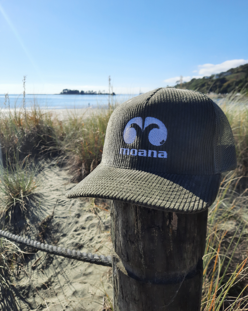 Moana OG Cord Trucker Cap in Olive green on the beach