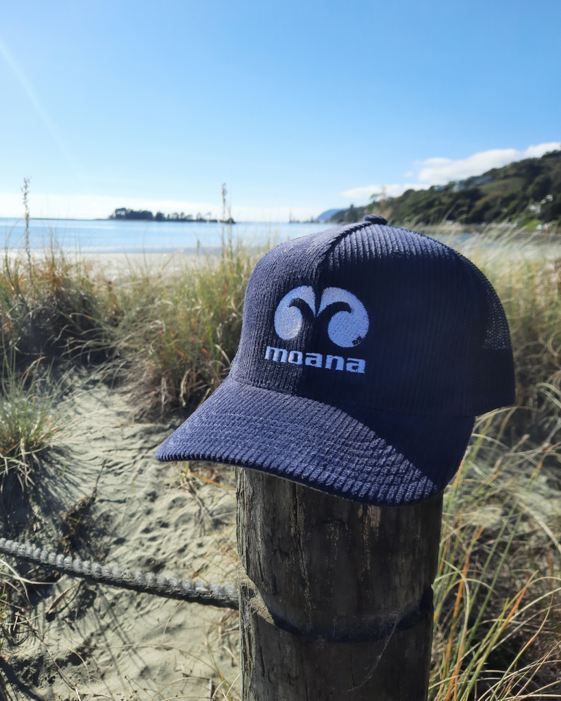 Moana OG Cord Trucker Cap in navy on the beach