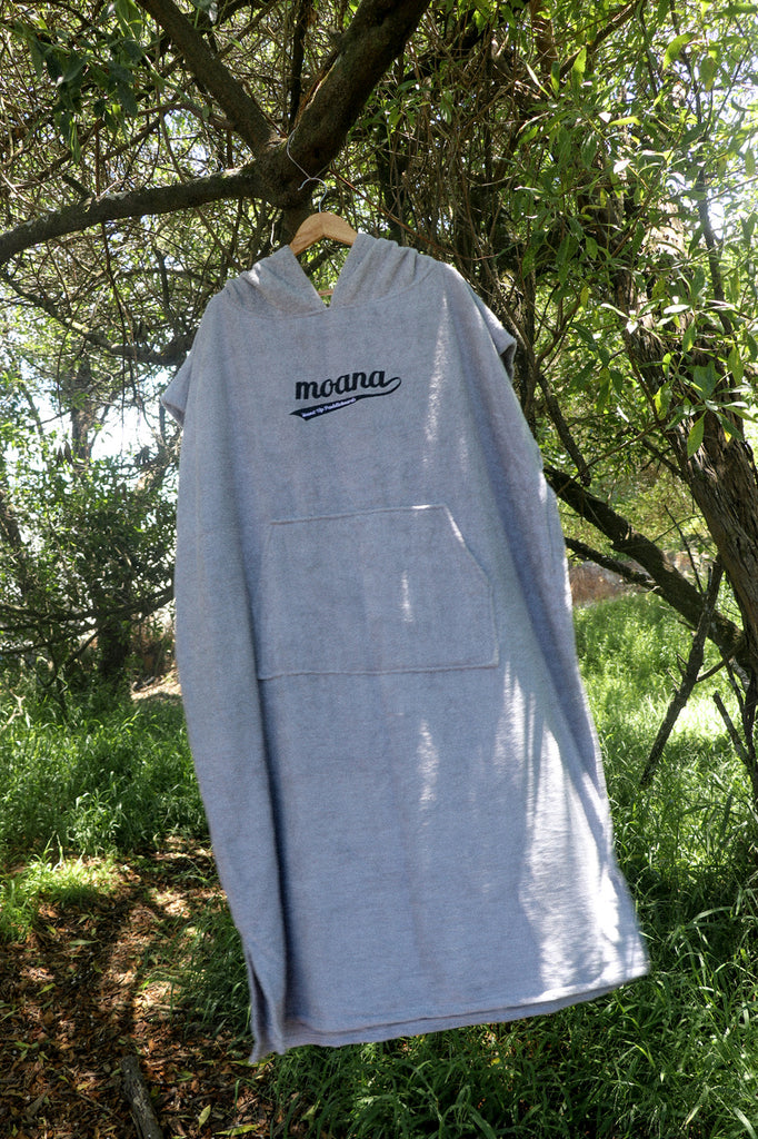 Moana hooded towel poncho grey hanging from a tree