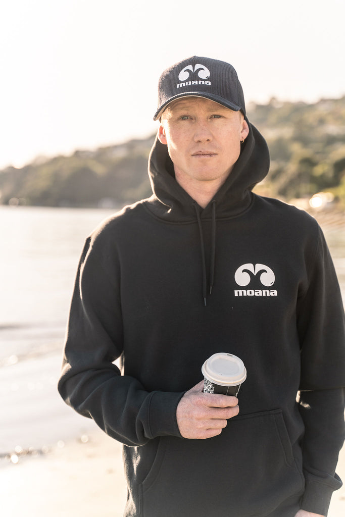Man at the beach wearing a Moana OG Cord Trucker Cap
