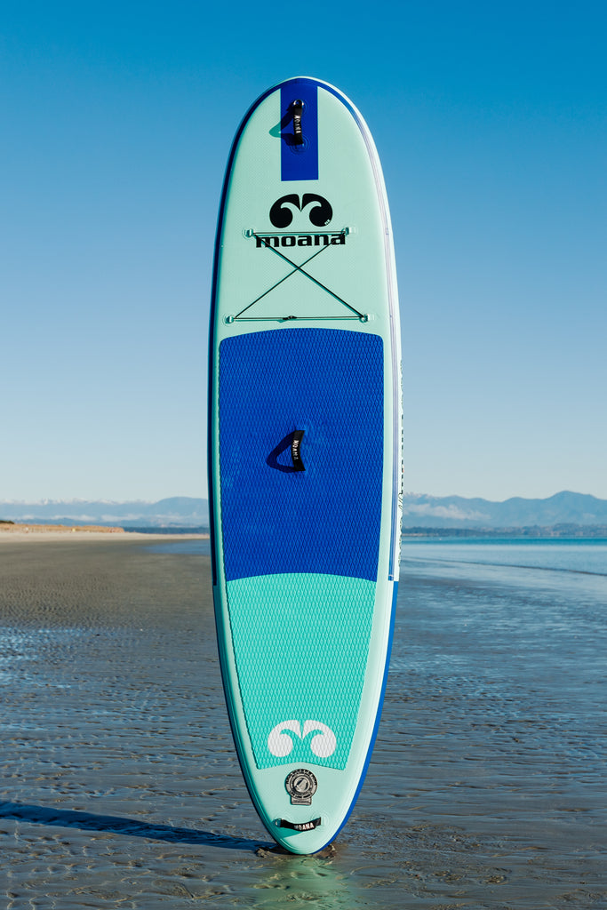 Moana Kikorangi 10'6" inflatable stand up paddleboard on the beach